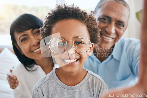 Image of Glasses, grandparents and selfie smile with kid in home living room, bonding and having fun. Photo, happiness and portrait of child with grandma and grandpa taking face pictures for family memory.