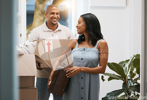 Image of Happy couple, real estate and moving in new home with box for property investment or relocation together. Man and woman realtor carrying boxes or luggage in the house with smile for mortgage loan