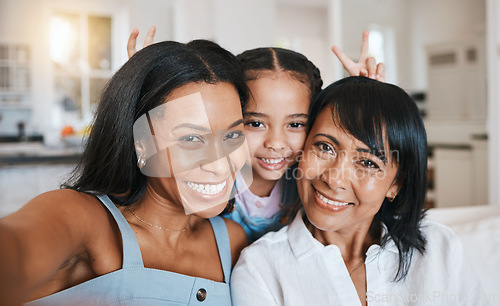 Image of Peace sign selfie, grandmother and child with mother in home living room, bonding or having fun. Family, smile and portrait of girl with grandma and mom, face or take photo with v hand emoji together