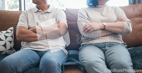 Image of Angry couple, fight and arms crossed with divorce, marriage and break up problem in living room. Home, sofa and woman and man together with conflict and anger from frustration in a relationship