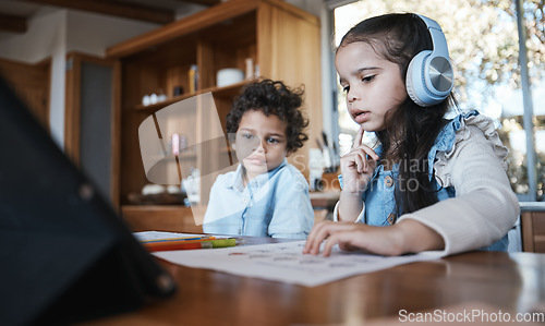 Image of Girl child, homework and thinking with headphones, music or little brother at desk in family home. School kids, study or confused with document for assessment, test or focus for education development