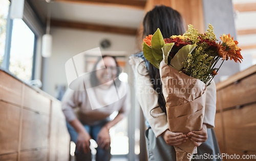 Image of Surprise flowers, mothers day and a mother and child for a gift, birthday or gratitude for care. Love, smile and a girl kid hiding floral bouquet from mom for celebration, special event or happiness