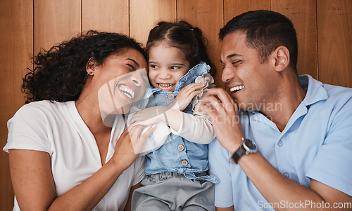 Image of Love, funny and family with girl, parents and hug with bonding, quality time and happiness. Mother, happy father and daughter with dad, mama and female child embrace, laughing and support at home