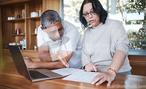 Image of Mature couple, finance and stress of debt in home for anxiety, insurance planning or mortgage bills. Frustrated man, woman and bankruptcy of financial crisis, poor savings policy or inflation problem