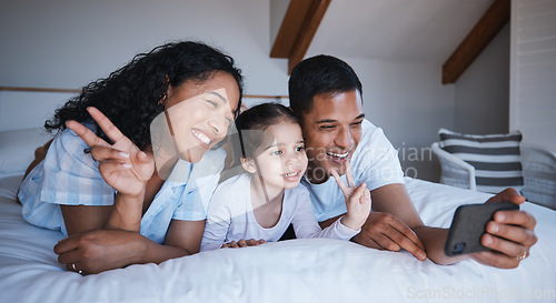 Image of Family, smile and peace sign selfie in bedroom, bonding or having fun together on bed. Hand gesture, happiness or kid, mother and father taking photo for social media, happy memory or profile picture