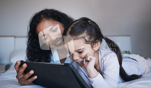 Image of Mother, tablet and kid relax on bed in home bedroom, social media or online browsing. Technology, happiness and mom and girl with touchscreen for learning, streaming film or video together in house