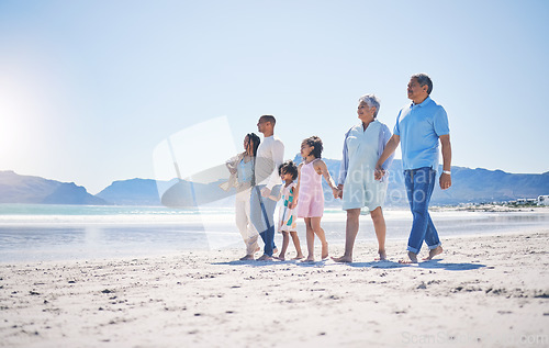 Image of Family, holding hands and walking at beach for mockup space by sea, sand or bond with love on summer vacation. Men, women and children for support, holiday and ocean mock up with waves in sunshine