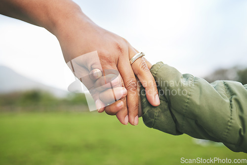 Image of Closeup, mother and child holding hands in park, morning walk and bonding with trust, support and love. Woman, kid and helping hand walking in nature for quality time in sunshine and holiday together