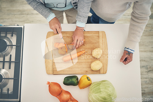 Image of Cooking, vegetables and couple hands cook food in a kitchen for healthy, vitamins and nutritions diet in a home. Meal, overhead and people preparing fresh produce together on cutting board for dinner
