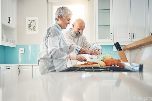 Image of Cooking, nutrition and a senior couple in the kitchen of their home together during retirement for meal preparation. Health, wellness or food with a mature man and woman making supper in their house