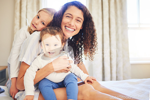 Image of Portrait, family and children smile with mother in home, bonding and having fun together. Happiness, bedroom and baby, girl and mama enjoying quality time with love, care and relax on bed in house.