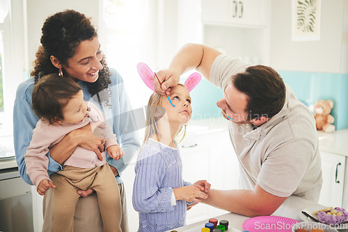 Image of Art, creative and happy with family and face painting for celebration, holiday and bonding. Easter, color and party with children and parents with bunny ears at home for happiness, vacation or relax