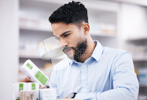 Image of Pharmacy stock, man and medicine retail check of a customer in a healthcare and wellness store. Medical, inventory and pills label information checking and reading of a male person by a shop shelf