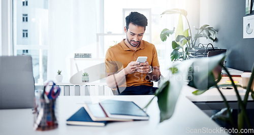 Image of Man with smile, phone and typing in modern office, checking social media meme or email. Happiness, internet and mobile app, creative designer at start up agency reading web review or feedback online.