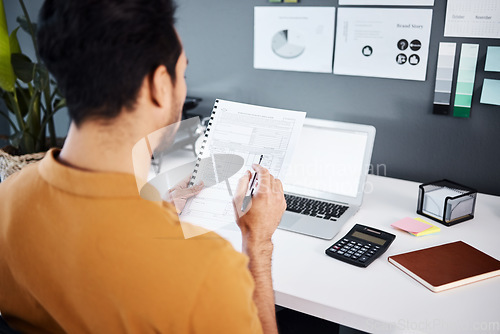 Image of Man, accountant and documents with laptop for finance, budget or strategy at office desk. Male employee working on financial paperwork, accounting or statements of company investments or expenses