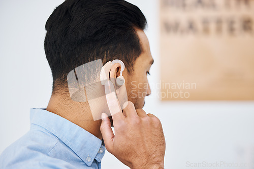 Image of Hearing aid, deaf and man with ear disability with medical support device as wellness innovation or audiology implant. Patient, auditory and male person with an amplifier for help listening