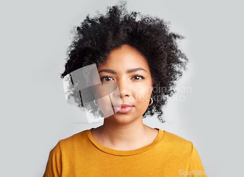 Image of Serious, woman and portrait in studio, white background and confident on backdrop. Face of young female model with curly hair, afro and cool attitude in casual fashion, style or gen z of South Africa