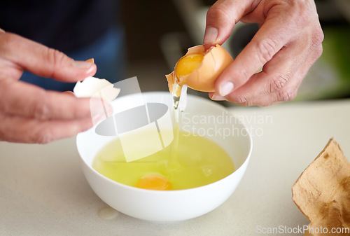 Image of Egg, food and hands cooking breakfast in the kitchen for hunger, preparation and morning routine. Diet, healthy and a man with eggs for protein, lunch and preparing a meal at home for health