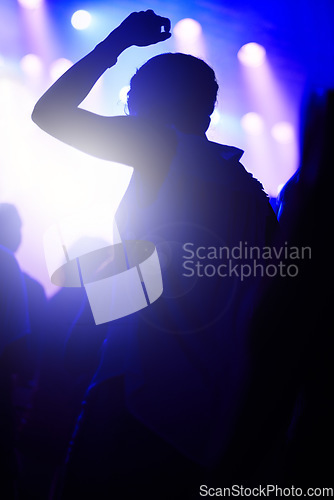 Image of Dance, neon and silhouette of woman at music festival with crowd dancing at concert, lights and energy at live event. Party, fun and group of people, excited fans in arena at rock band performance.