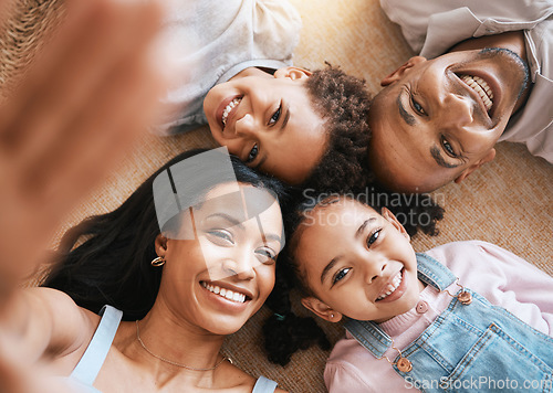 Image of Family, selfie portrait and top view smile, bonding or having fun together. Parents, happiness above and children relaxing or lying on carpet floor with profile picture, face or enjoying time in home