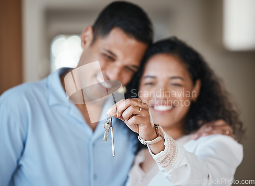 Image of House keys, new home or happy couple hug in real estate, property investment or buying an apartment. Blurred, love or Indian man hugging an excited woman to celebrate goals or moving in together