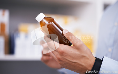 Image of Pharmacy, medicine and hands of man with bottle reading label for medication, prescription and information. Healthcare, clinic and closeup of person with medical product, supplements and antibiotics