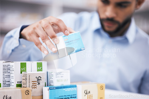 Image of Pharmacy stock, man hands and retail check of a customer in a healthcare and wellness store. Medical inventory, drugs box and pharmaceutical label information checking of a person by a shop shelf