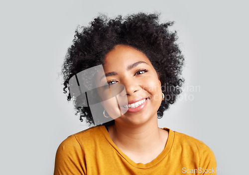 Image of Portrait, smile and happy woman in studio calm, relax and posing against a grey background space. Face, cheerful and excited African female confident, natural and content, casual and beautiful