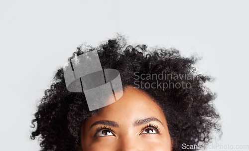 Image of Woman, eyes looking up and cropped in studio with thinking, ideas and hope by gray background. Young female model, african girl and think for mindset with afro, vision and daydream by backdrop