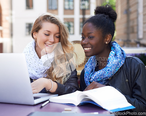 Image of Communication, women students at campus with laptop and book. Teamwork or collaboration, females working together on university or college assignment and friends laughing or smiling at table