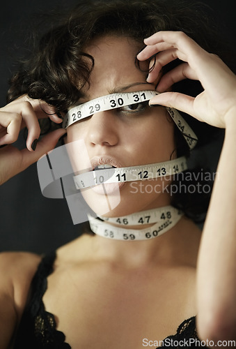 Image of Anorexia, measuring tape and cover with face of woman for eating disorder, weight loss and fear. Diet, frustrated and mental health with female for anxiety, stress and bulimia problem or issue