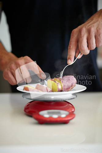 Image of Scale, food and man weigh vegetable in kitchen to measure portion for calories, nutrition and balance diet. Cooking, meal prep and hands of male person cutting vegetables for lunch, dinner and supper