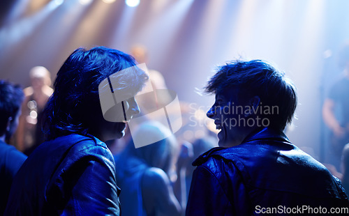 Image of Excited men, friends and fans at music festival, lights and crowd in silhouette at live band performance on stage. Happiness, people with smile and blue lighting, excitement at rock concert together.