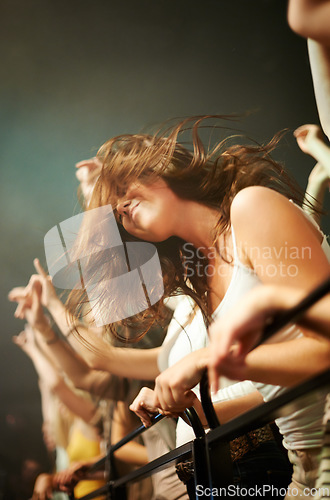 Image of Fence, dancing and woman in crowd at concert or music festival, happiness at rock event. Girl in audience, excited fan at live band performance in arena or stadium with dance and energy at night show