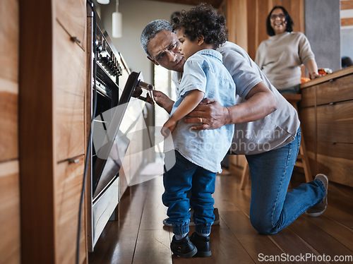 Image of Senior man baking with his grandchild in the kitchen while bonding with love, care and happiness. Cooking, family time and elderly male person in retirement working oven with a boy kid in modern home