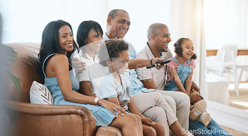 Image of Happy, big family and watching tv on the sofa together, enjoying a film or comedy show at home. Smile, living room and parents, grandparents and children laughing at the television for happiness