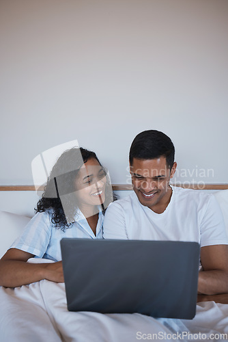 Image of Laptop, relax and happy couple in bed, bonding and enjoying streaming, movie or browsing in their home. Online, movie and man with woman in a bedroom for weekend, entertainment and subscription