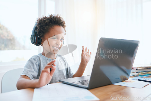 Image of Happy, remote and a child waving on a video call for education, elearning and online class on laptop. Smile, wave and a student greeting for digital school communication from home on a computer