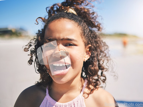 Image of Child, beach and portrait in nature with a young girl and smile on summer holiday. Face, closeup and African female child at the sea on vacation feeling happy from the ocean and outdoor fun in sun