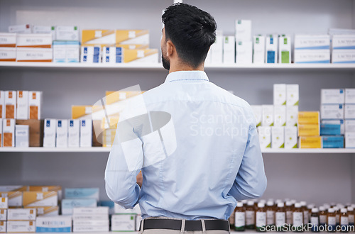 Image of Pharmacy, medicine and back of man check shelf for medication, prescription and treatment. Healthcare clinic, drug store and male person reading boxes for medical product, supplements and antibiotics