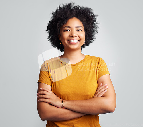 Image of Happy, woman and arms crossed for portrait in studio, white background and backdrop. Young female model, smile and natural curly afro hair with positive personality, gen z and girl of South Africa