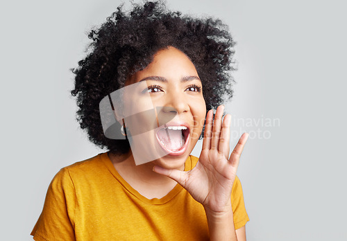 Image of Young woman and shouting or holding hand near wide open mouth or calling someone and yelling information on grey studio background. Loud, announcement and girl screaming interesting news