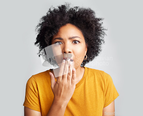 Image of Surprise, wow and woman covering mouth with hand isolated on a white background in studio. Shocked, face and African female person amazed, omg or surprised reaction to news, emoji or fear portrait