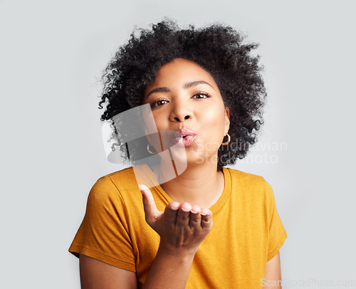 Image of Portrait, woman and blowing kiss in white background, studio and backdrop of love, romance and flirting lips. Happy african female model, air kissing and emoji for happiness, joy and valentines day