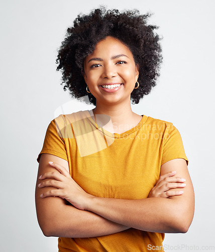 Image of Portrait of happy, woman, arms crossed and confident in studio, white background and backdrop. Young african female model smile with natural curly hair, positive face and gen z girl of South Africa