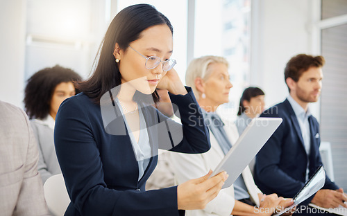 Image of Conference meeting, tablet and woman reading digital notes, online data or seminar report for business analysis. Tradeshow audience, convention crowd and Asian person review presentation research