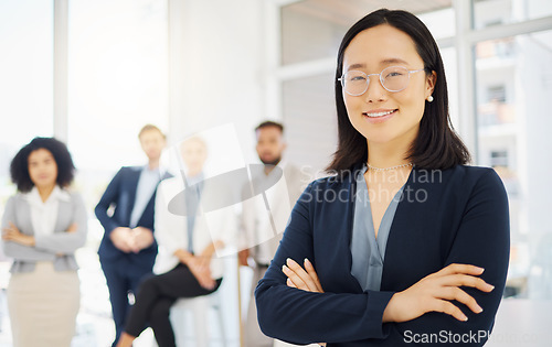 Image of Business, happy and portrait of Asian woman in office with confidence, pride and motivation with team. Leadership, diversity and female worker with smile for success, company mission and happiness