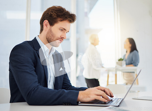 Image of Serious, thinking and business man working on a laptop in a office with website data and planning. Entrepreneur, management worker and online database analyst typing on a computer for a web update