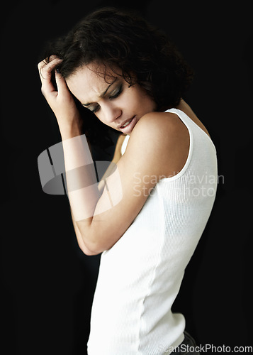 Image of Depression, dark and woman with mental health problem, anxiety or bipolar isolated in a black studio background. Headache, pain and depressed female person with psychology issue or identity crisis