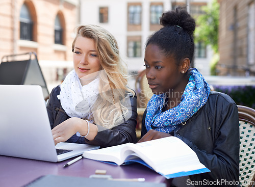 Image of Woman, friends and students studying on laptop with book together for higher education, learning or university in city. Student women working together to study or group project on computer in town